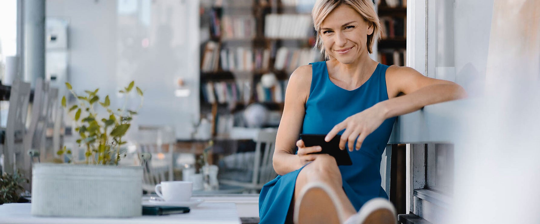 smiling woman holding a tablet